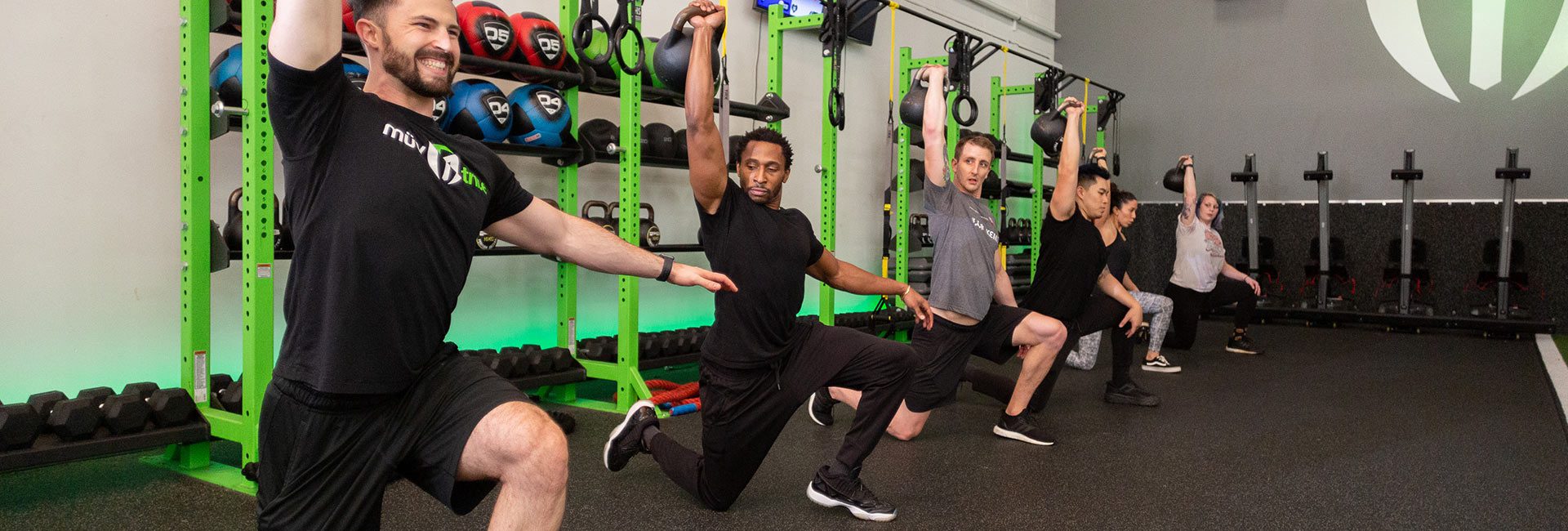 group using workout equipment in gym near me