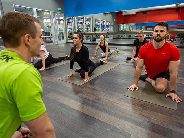 People in Yoga Class Stretching in muv Fitness Center in gym near me