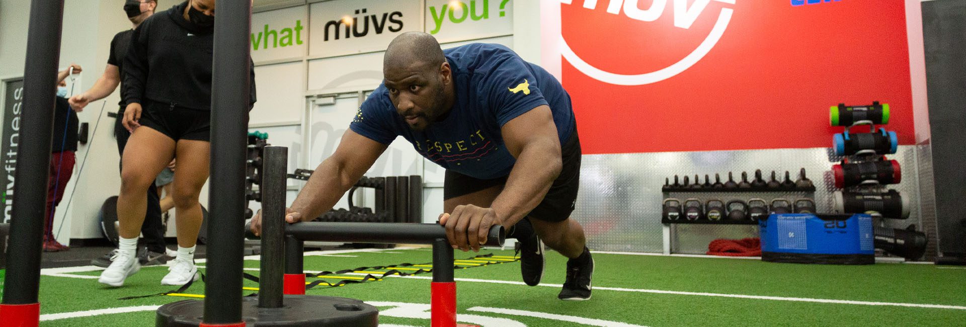 man pushing weights in gym