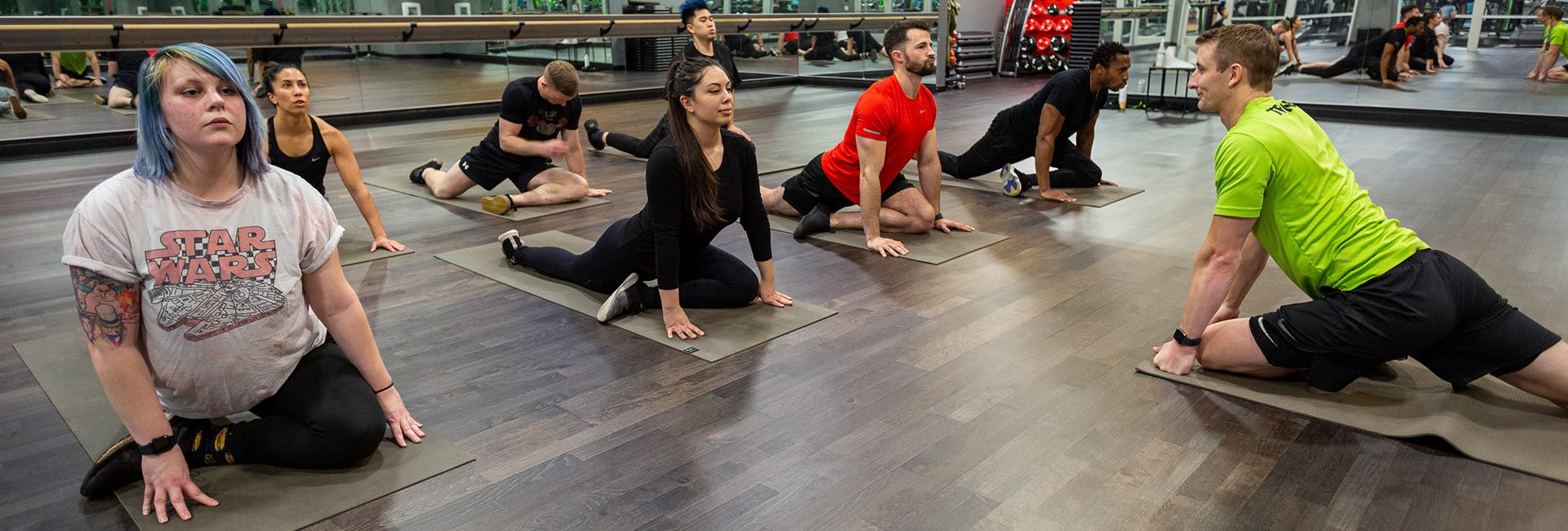 group doing yoga in gym near me