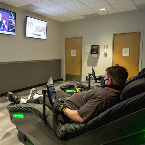 man receiving hydromassage in muv fitness center