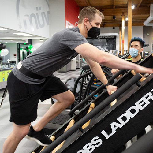 man using gym ladder machine in gym near me