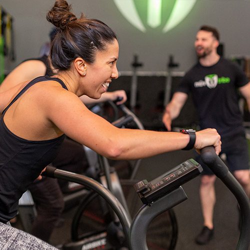 woman using cardio machine in gym