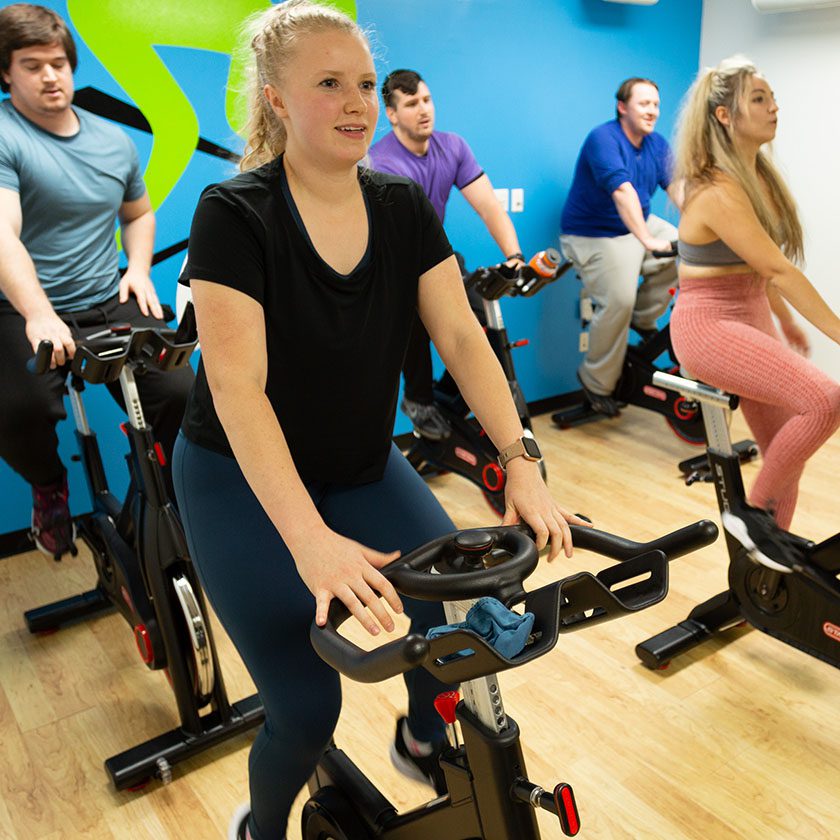 group fitness exercise class on bikes