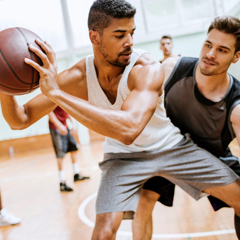 men playing basketball in a gym