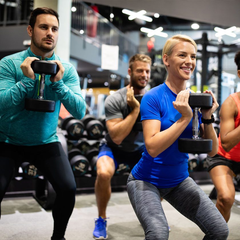 gym members training with a trainer in a modern gym