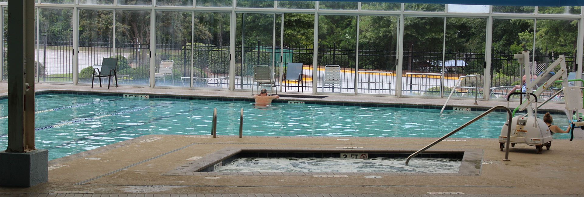 man lounging in a pool at a gym