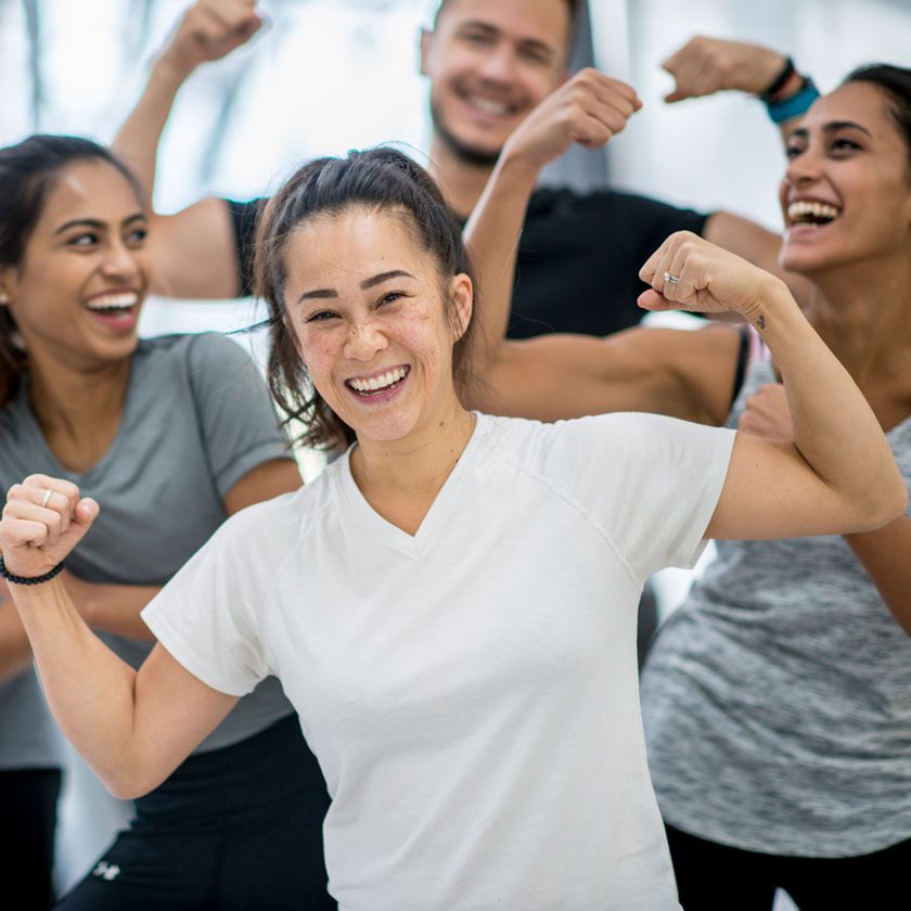 woman smiling with other gym members