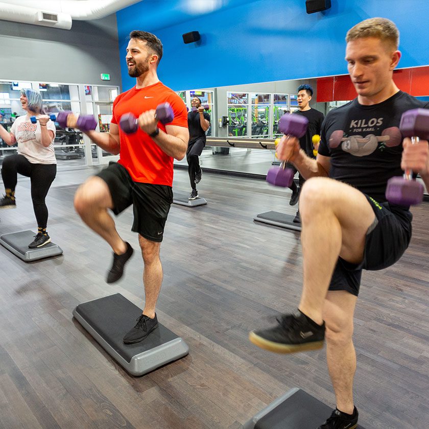 group bootcamp class with men and women using weights at a gym in north spokane