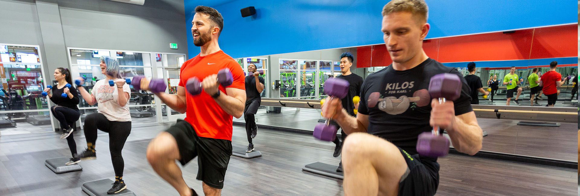 group bootcamp class with men and women using weights at a gym in north spokane