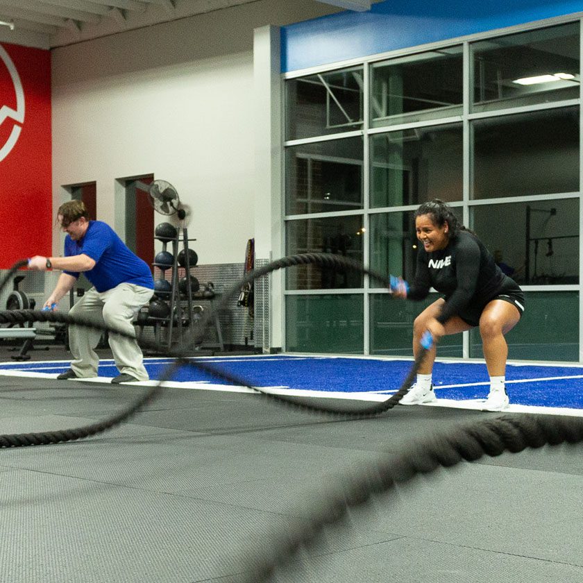 battle ropes being used by a man and woman exercising at a gym in north spokane