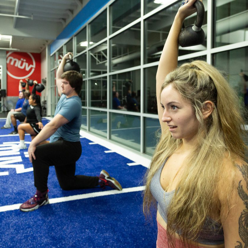 group fitness class doing strength training with kettlebells at a gym near me in north spokane