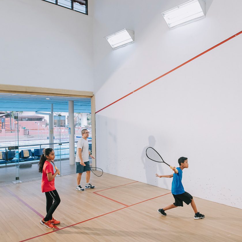 family playing racquetball at a gyms indoor court in north spokane