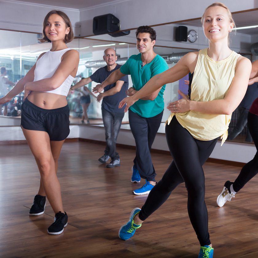 group zumba class with people smiling at a gym in north spokane