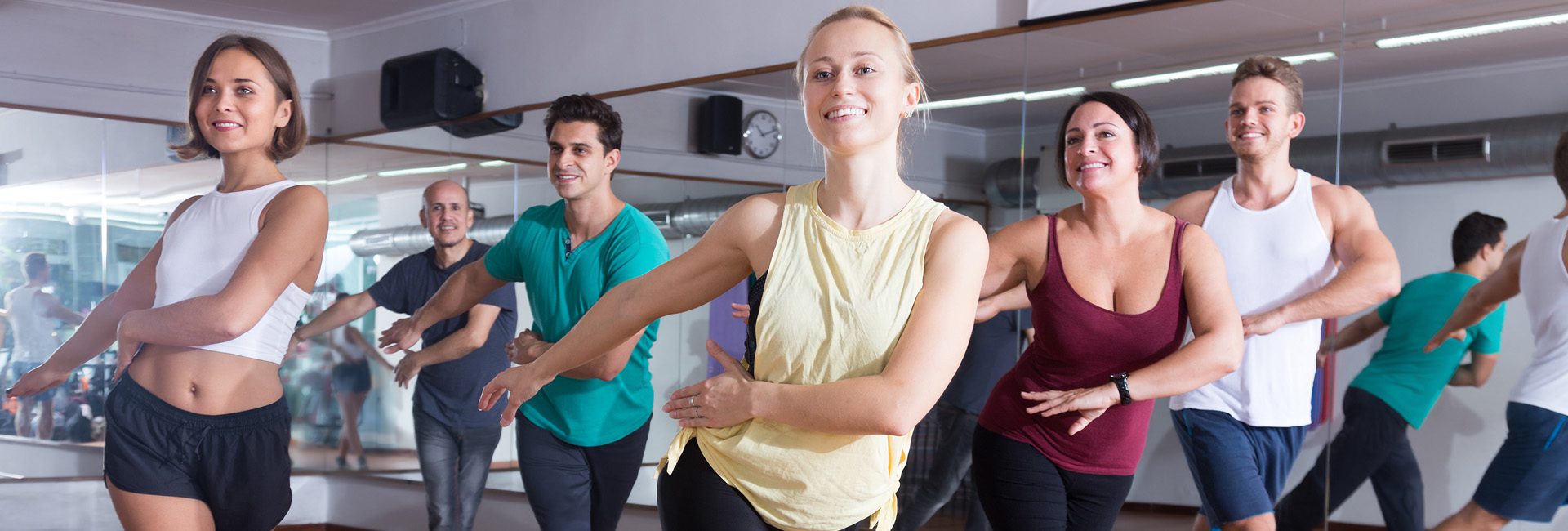 group zumba class with people smiling at a gym in north spokane