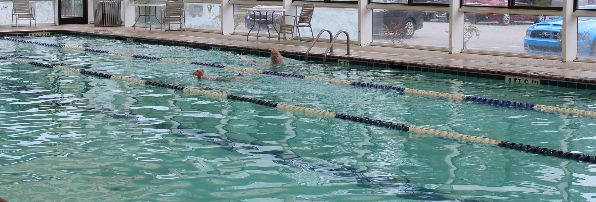 person swimming in a gym pool