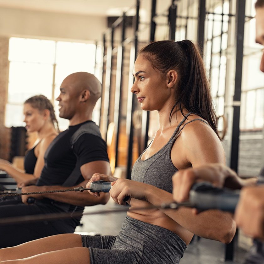 people in a training class using row machines