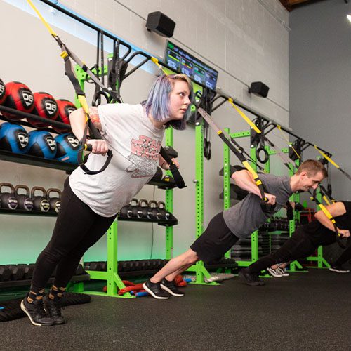 group using rope equipment in gym