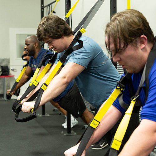 group working out with equipment in muv fitness center