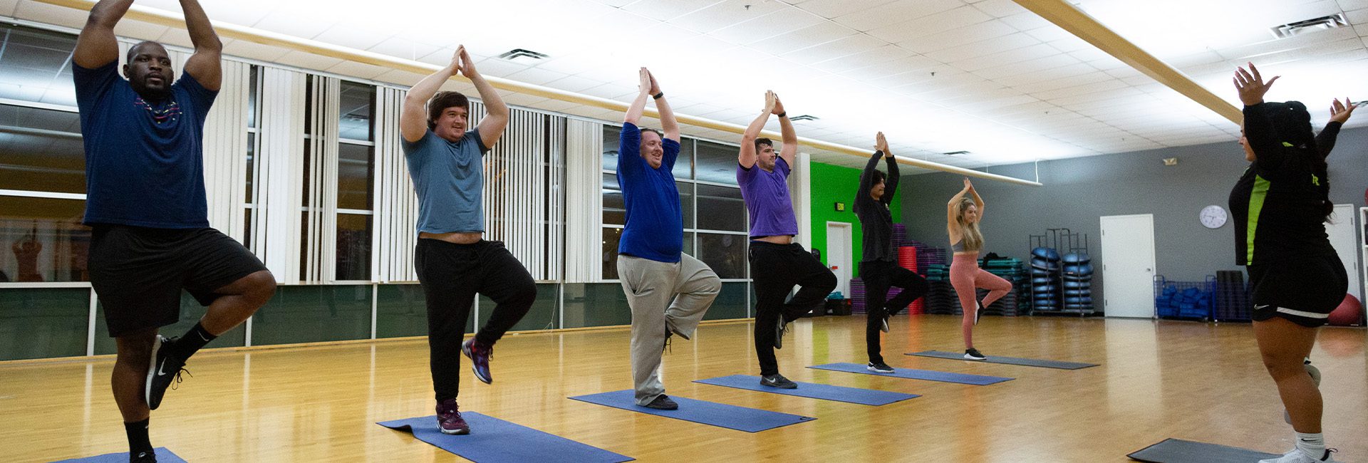 group doing yoga in gym