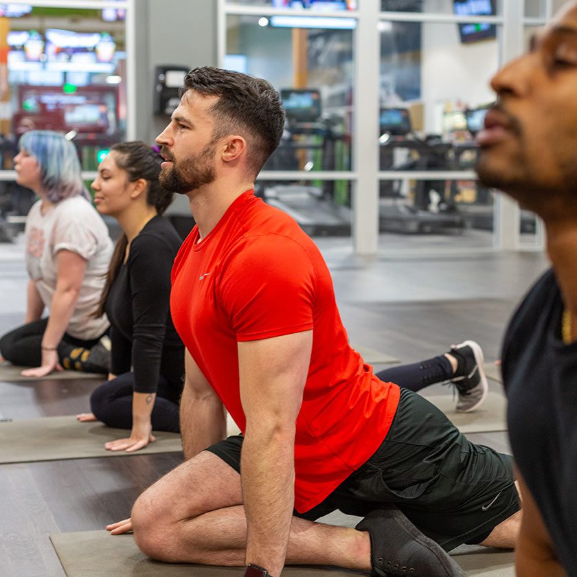 man doing yoga in gym