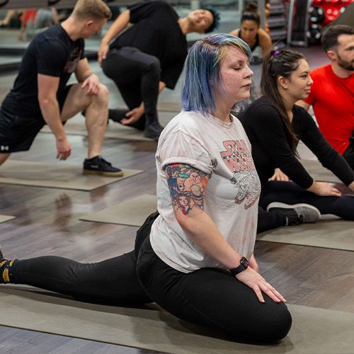 woman in a yoga class doing a pose