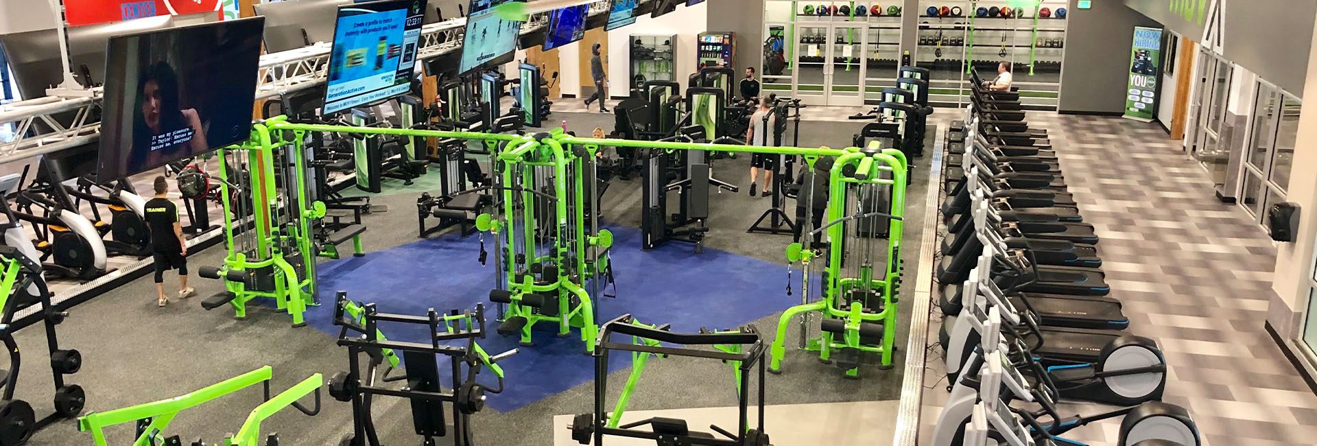 people working out in an indoor spacious gym