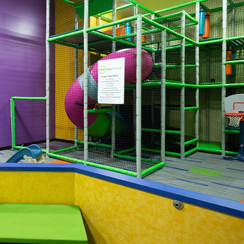 room with a slide for children in a gym