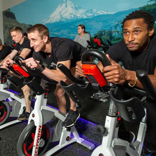 group of people in an intense group fitness spin class