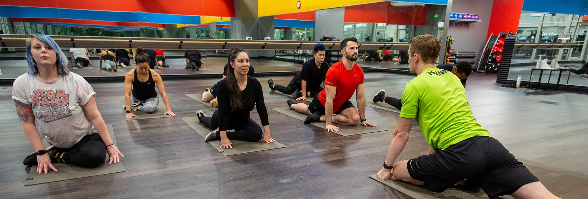 group of people doing a yoga pose in a class