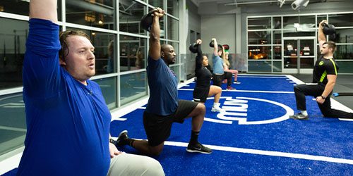 people working out in a group with kettlebells
