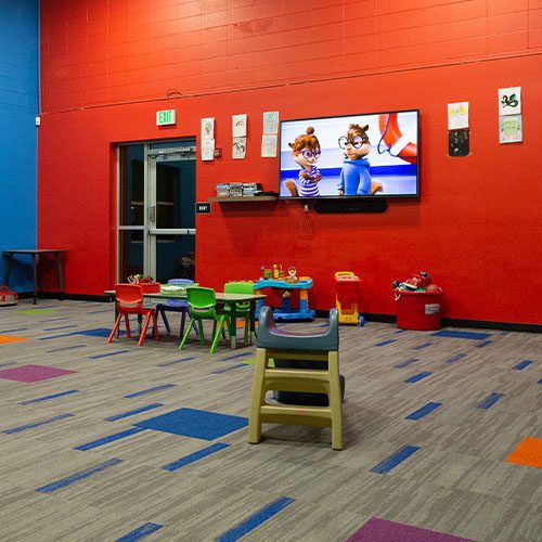 room full of toys and a tv in modern gym