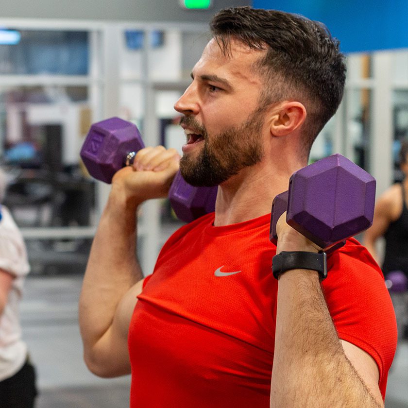 man lifting weights at a Troutdale gym