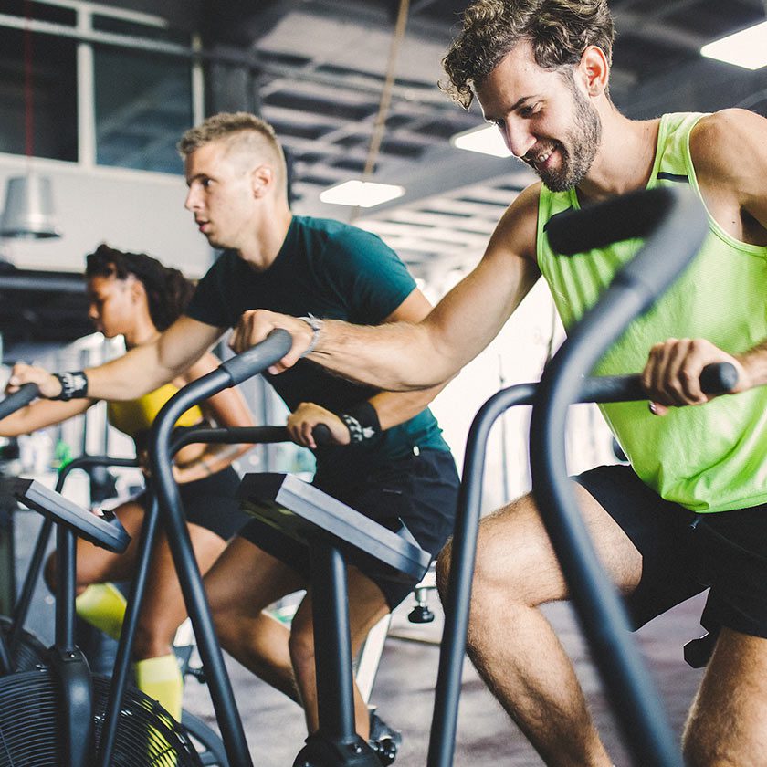 group using cardio machines in gym