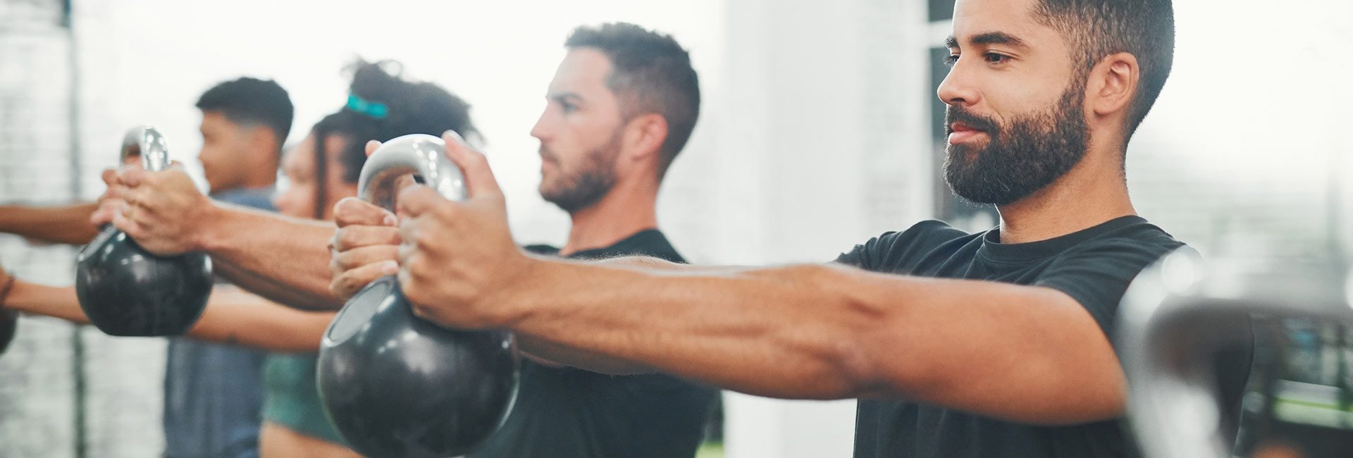 group working out with kettlebells