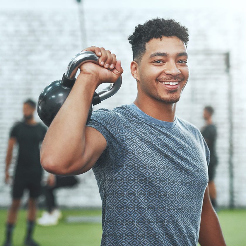 man holding bell weight