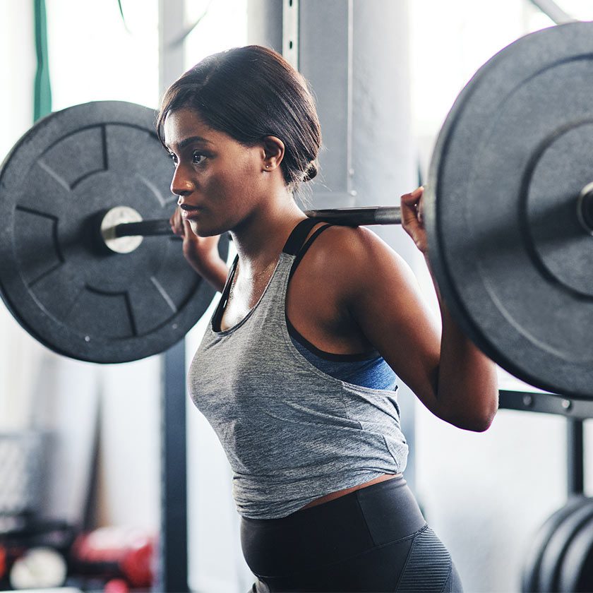 woman squatting weights