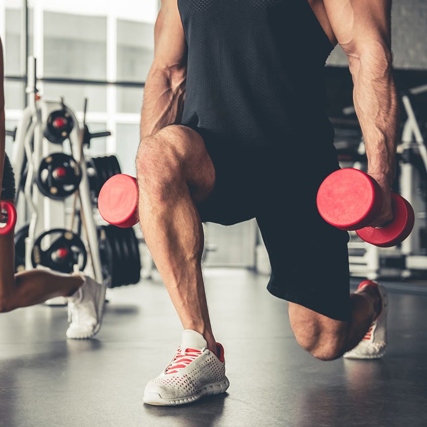 man lifting weights in gym