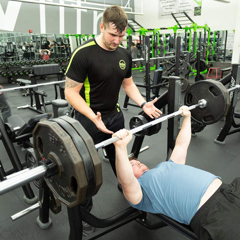 personal trainer an client working out in best gym near me