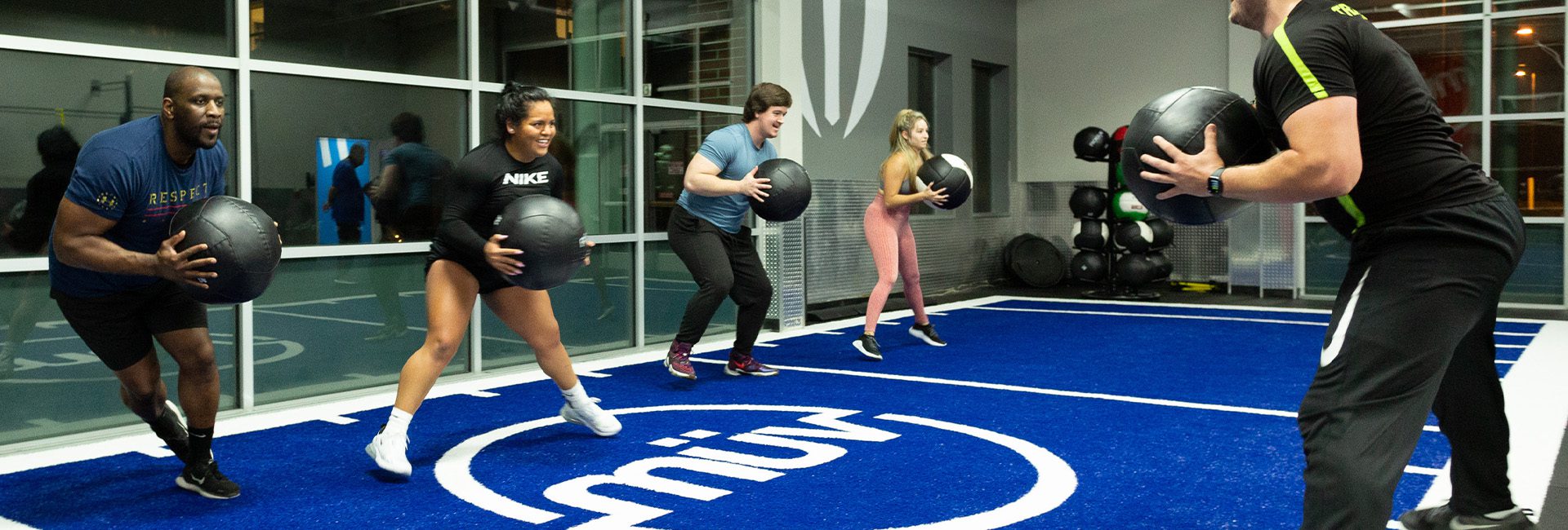 group of people training with a certified trainer in a gym near me