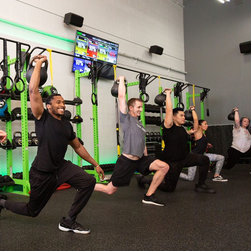 group of people training with a certified trainer in a gym near me