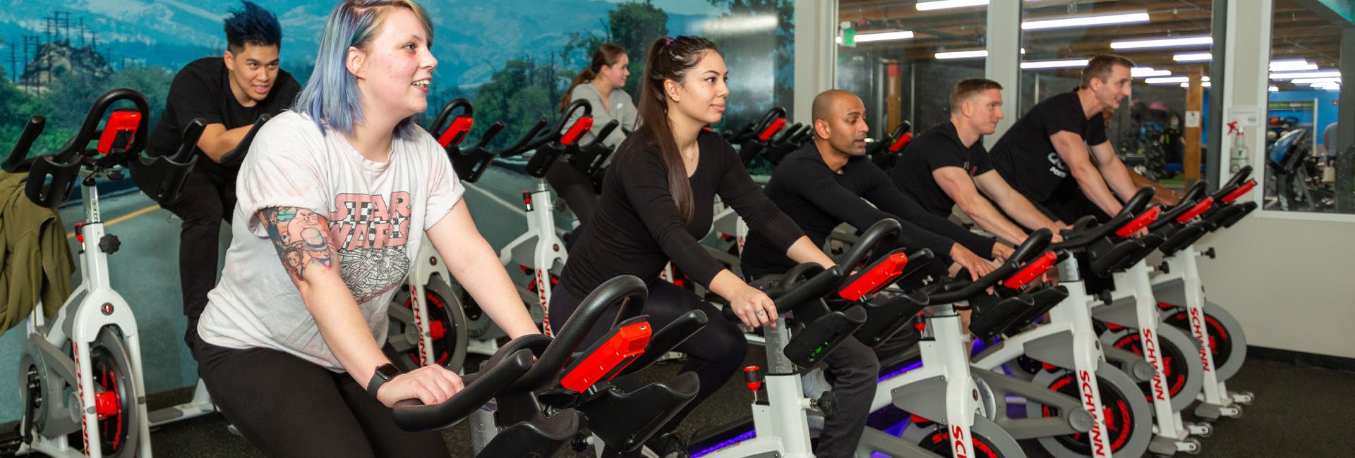 group of people in a spin class in a modern gym near me