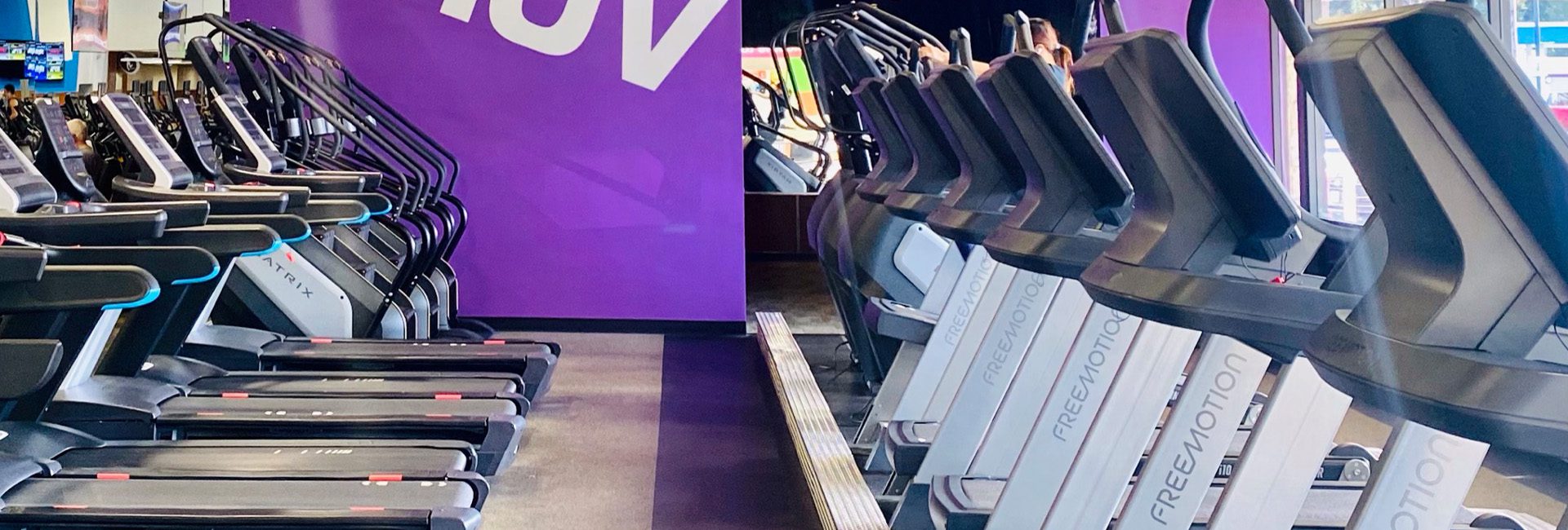 rows of treadmills and cardio equipment in the best gym near me
