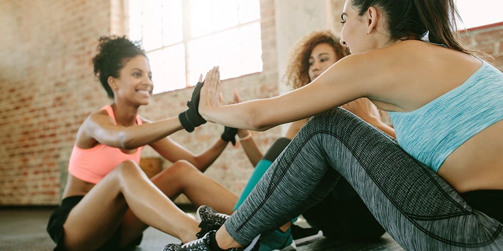 women clapping hands in group class