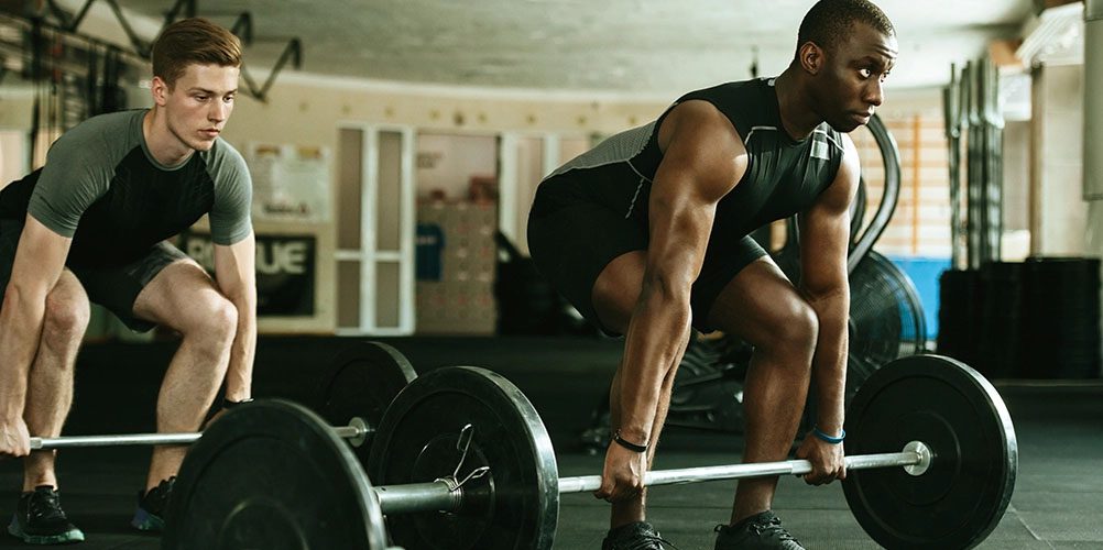 men lifting barbell